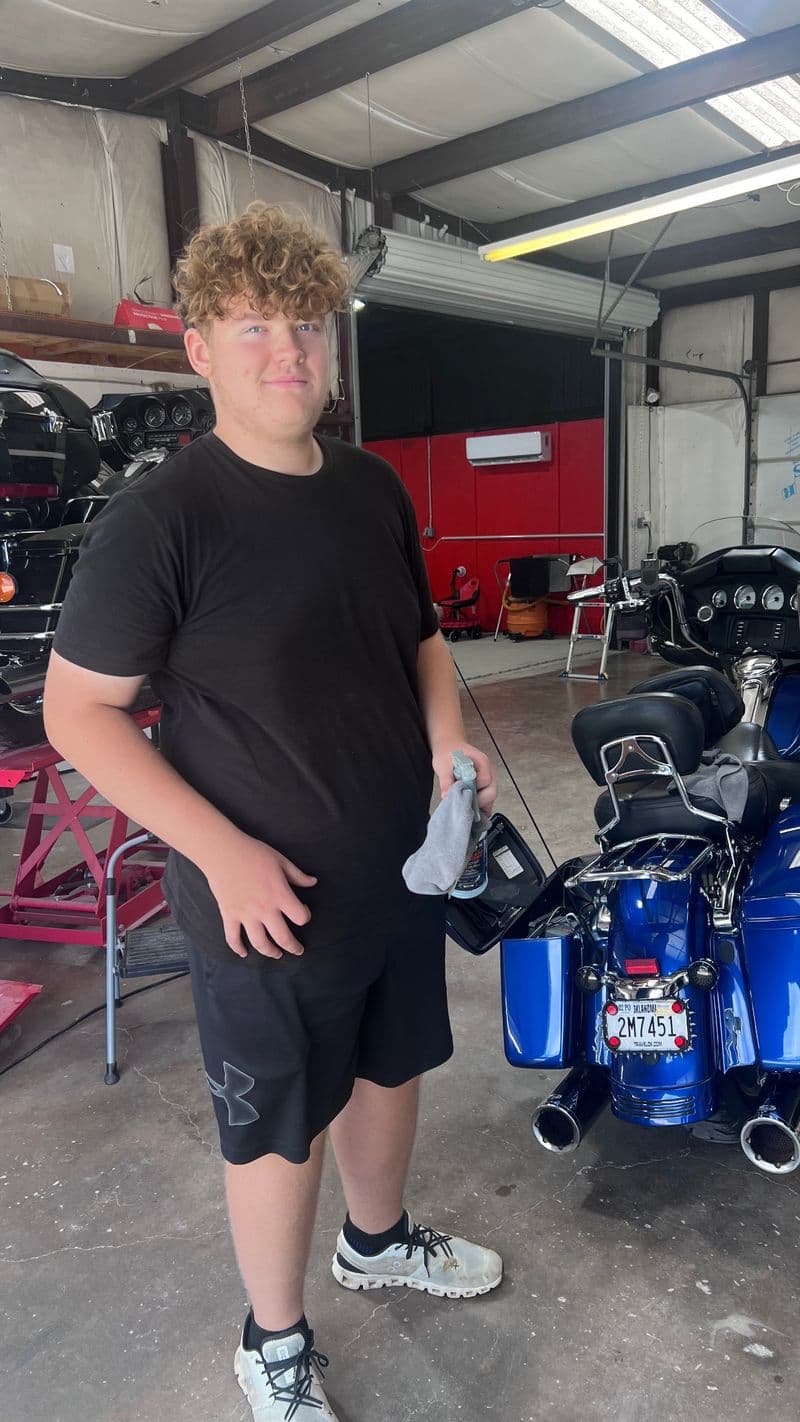 Customer picking up his freshly detailed Harley-Davidson touring motorcycle at Grimeaway Autoworks