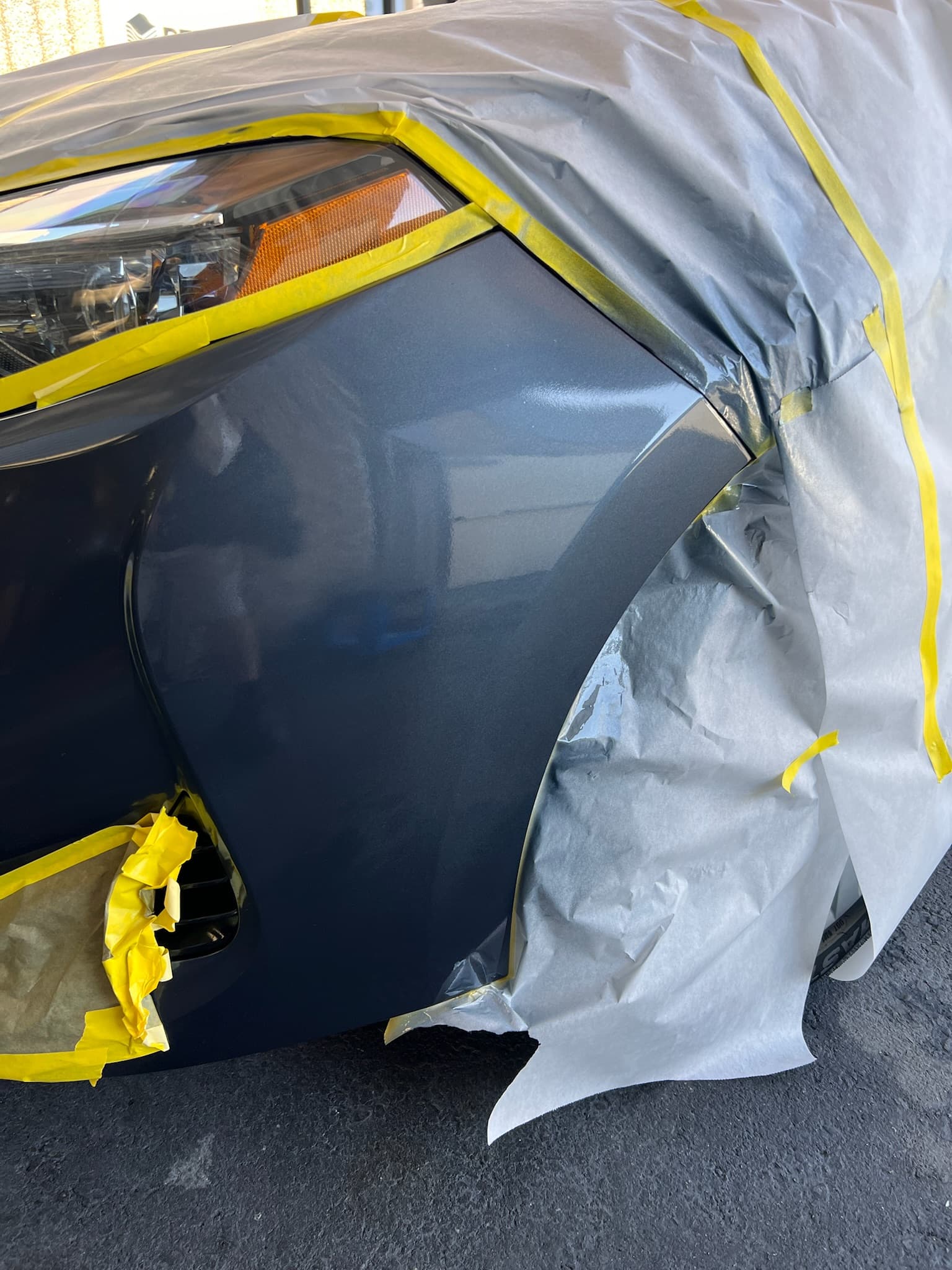Masked panel prepped for paint chip repair