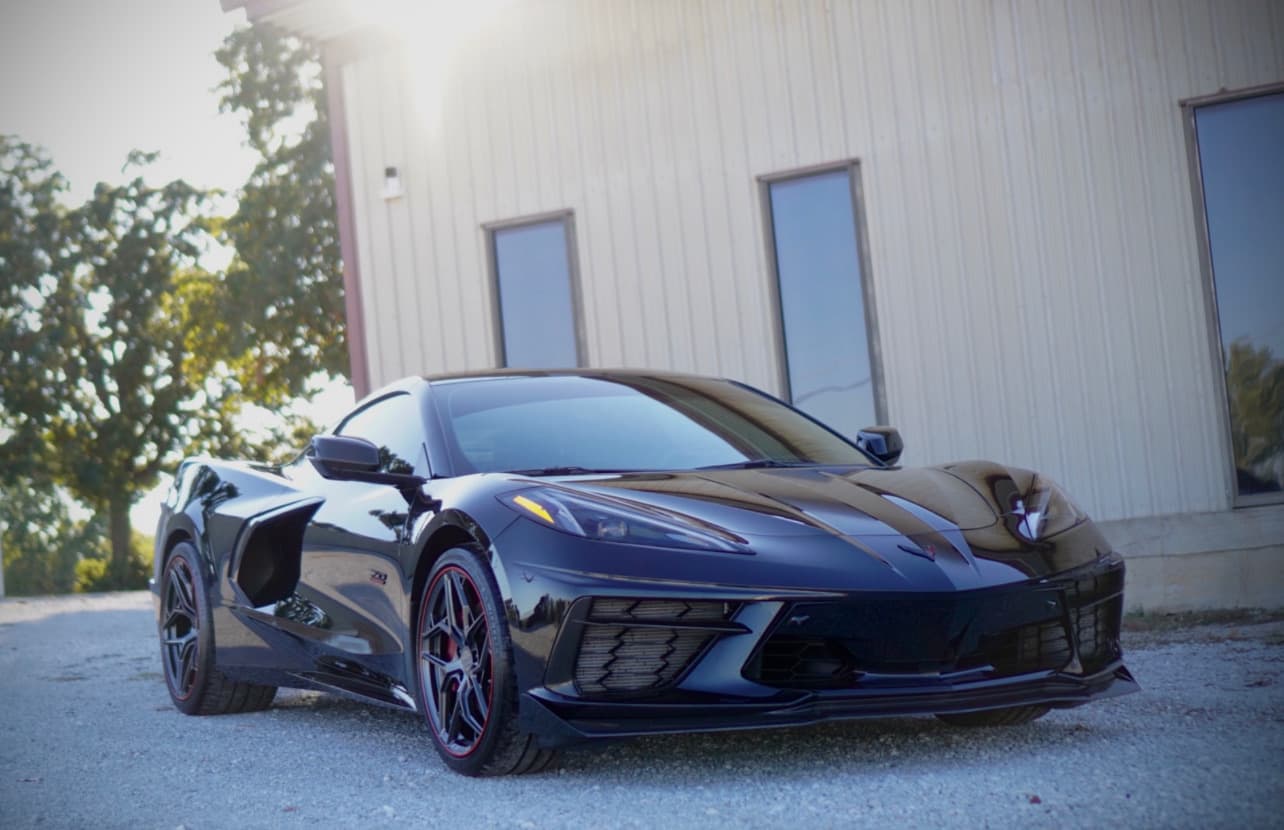 Corrected black sports car outside the Grimeaway Autoworks shop