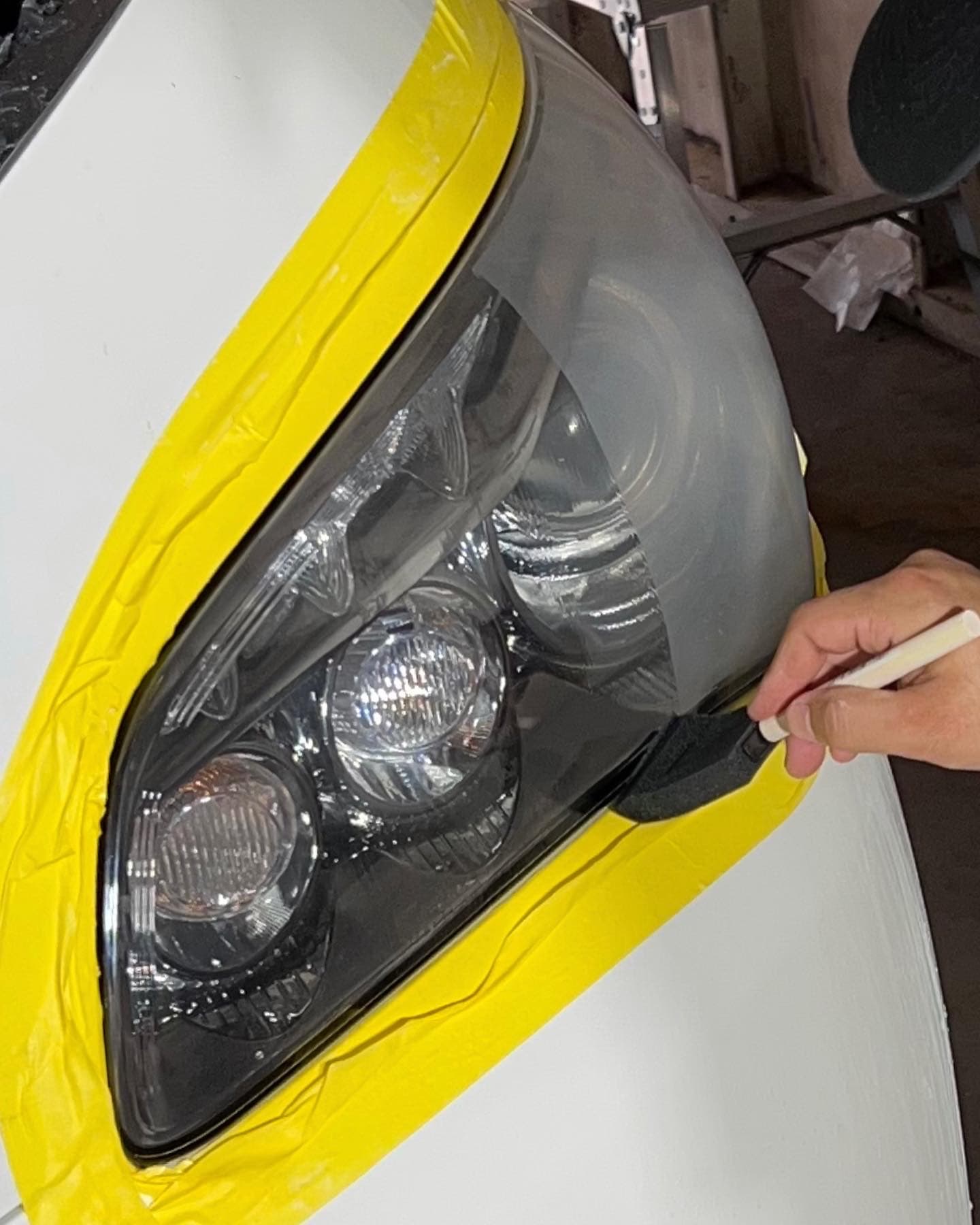 Headlight restoration prep with masking tape