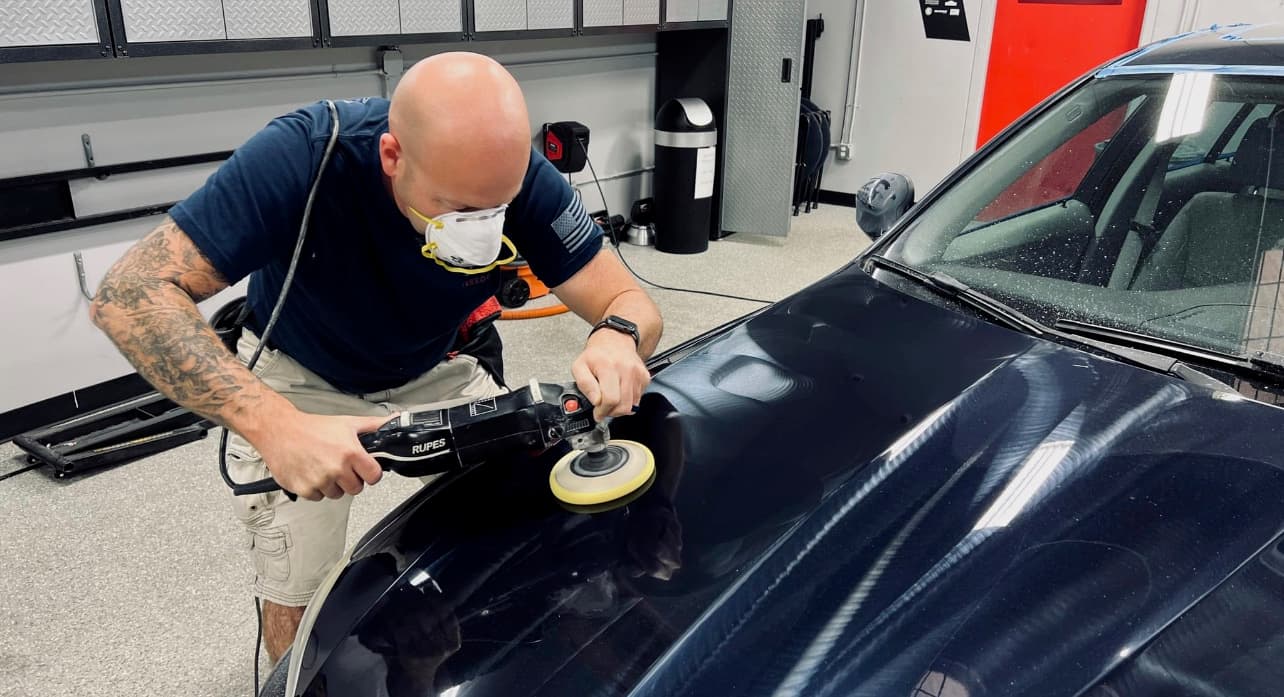 Polishing a vehicle’s clear coat at Grimeaway Autoworks