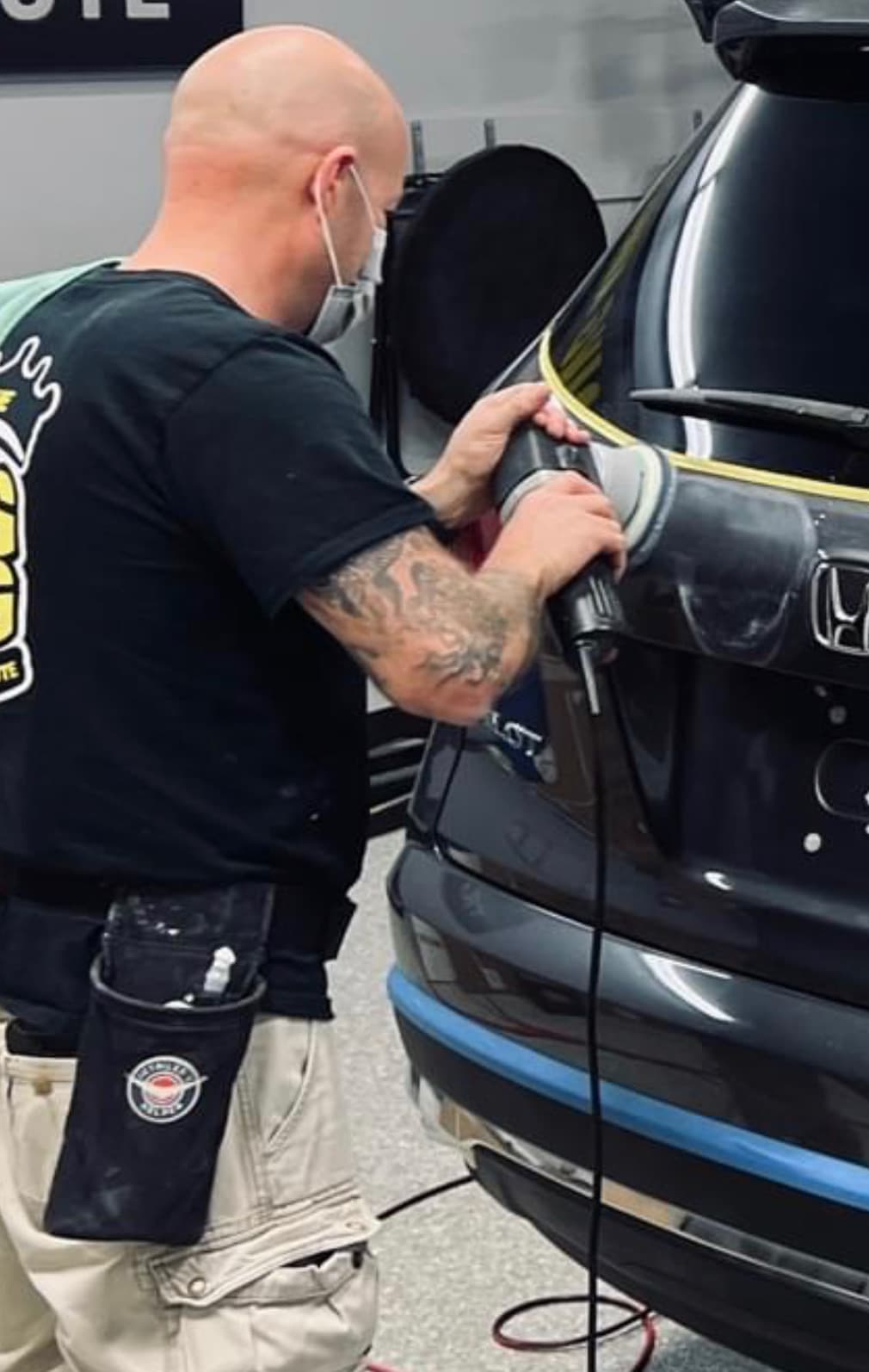 Technician refining a corrected finish