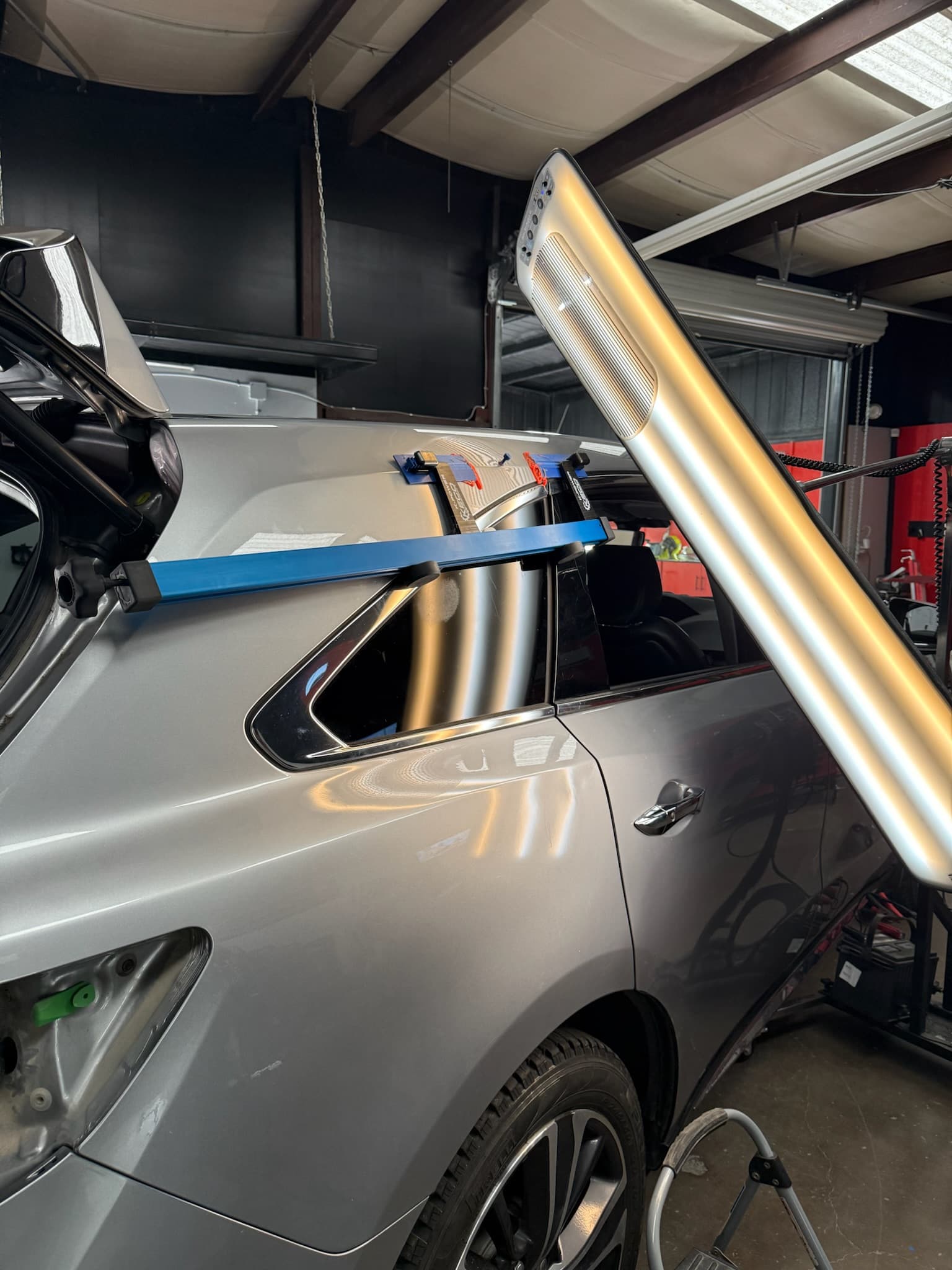 Paintless dent repair on a silver truck panel
